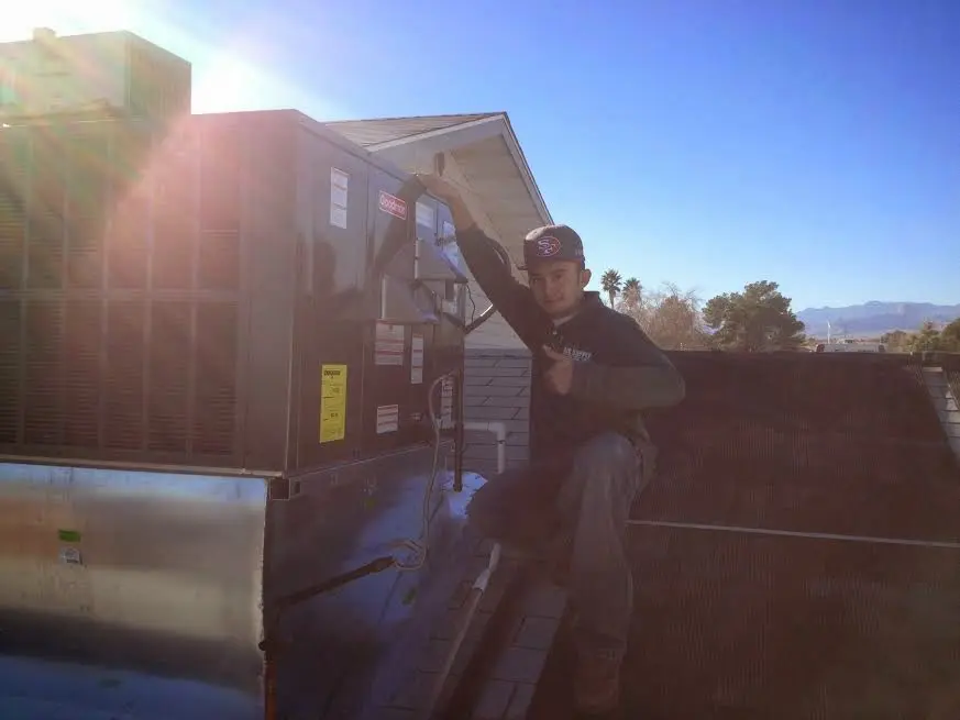 HVAC technician performing HVAC Inspection on a rooftop unit in Chesterfield